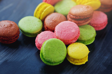 colorful macarons on black background