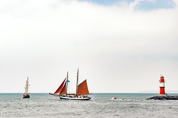 Sailing ships on the sea. Tall Ship and lighthouse Yachting travel.