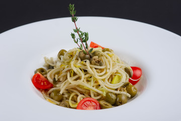 Traditional lenten spaghetti with shallot, tomato, rosemary and olives