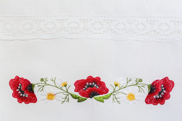 Embroidered floral pattern on a white linen towel