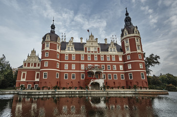 Moat and New Castle in the park Muskauer in Germany.