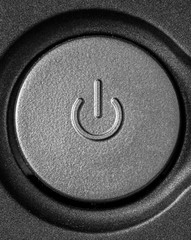 Power button in black and white with a grainy texture.