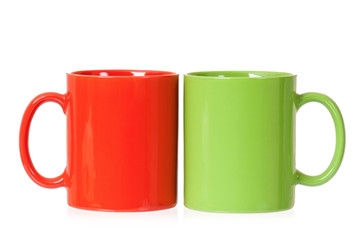 Two mugs - green and red - for coffee or tea, isolated on white background