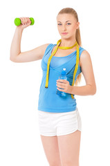 Naklejka premium Young woman doing fitness exercise, isolated on white background. Portrait of beautiful athlete girl with bottle of water, dumbbells and tape measure in studio.
