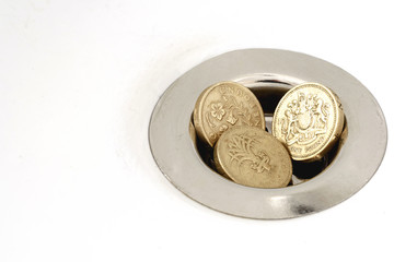 Three Pound Coins Money Down the Drain