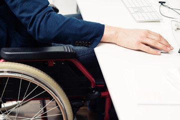 Obraz premium Man Sitting In Wheelchair Working In Modern Office