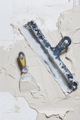Trowel and spatula with cement. Dirty tools for repair