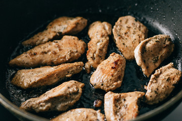 Fried meat in a frying pan. fatty junk food