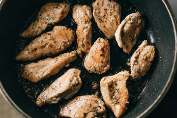 Fried meat in a frying pan. fatty junk food