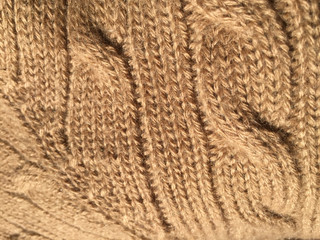 Close-up background of hand-knitted textured detail. Beautiful artistic surface