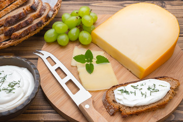 Cheese with knife on board