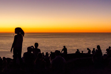 Fototapeta na wymiar Silhouetted People at Sunset