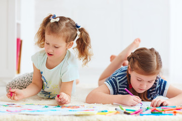 Fototapeta premium happy young girls, kids painting with felt pen together