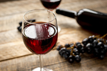 Wine set with bottle and grape on wooden desk