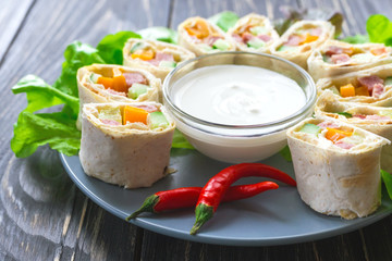 Pita rolls with bell paper and ham. Healthy breakfast