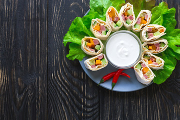 Pita rolls with bell paper and ham. Healthy breakfast