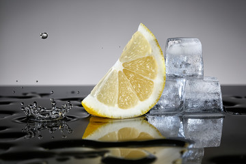 Lemon with water drop and ice cubes