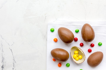 Easter chocolate eggs top view on stone background mock up