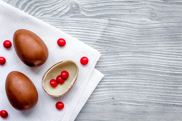 Easter chocolate eggs top view on wooden background mock up
