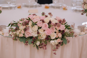 Beautifully decorated bouquet of roses in compose with candles