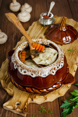 Dumplings in a pot on a wooden table