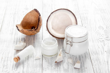 organic cosmetics with coconut on wooden background close up