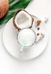 cocktail with coconut on white background top view