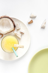 cocktail with coconut on white background top view