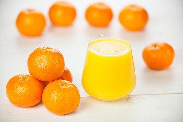 Delicious fresh squeezed tangerine juice in  transparent glass
