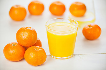 Delicious fresh squeezed tangerine juice in  transparent glass