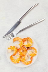 delicious appetizing prawns on white plate on white