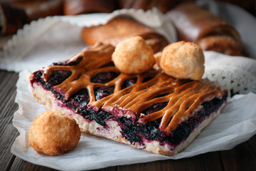 Tasty fruit pie with cookies on wooden table