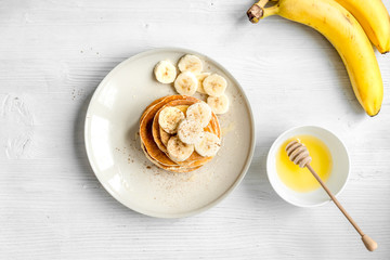 cooked pancake on plate top view at wooden background