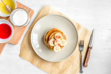 cooked pancake on plate top view at wooden background