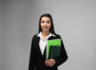 Beautiful young teacher on light background