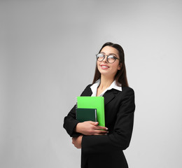 Fototapeta premium Beautiful young teacher on light background