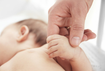 Mother holding little baby's hand, closeup