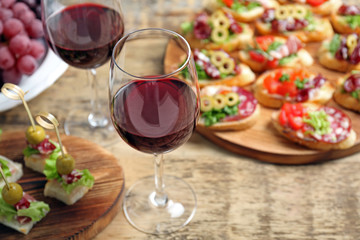 Wine with tasty bruschetta served on table