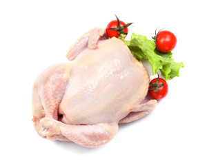 Whole raw chicken with lettuce and tomato on white background