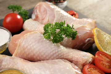 Raw chicken legs with spices, closeup