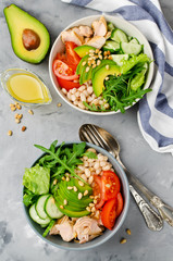 Salmon with white bean, tomatoes, cucumbers, avocado and arugula salad