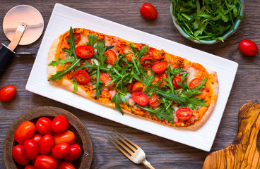 Home maid fresh pizza with tomatoes, rucola and mozzarell