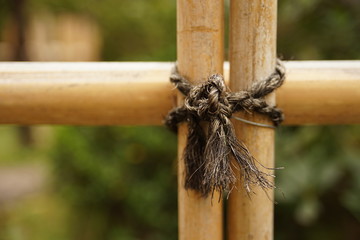 Rope tied on the bamboo fence close up shot - 138770602