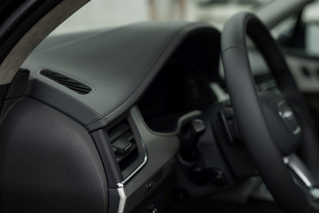 Fototapeta na wymiar Modern car leather dashboard. Interior detail.