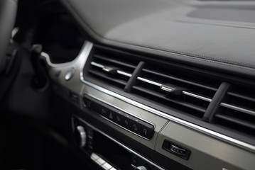Obraz na płótnie Canvas Modern car leather dashboard with control buttons. Interior detail.