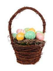 Easter basket filled with hand painted Easter Eggs over a white background