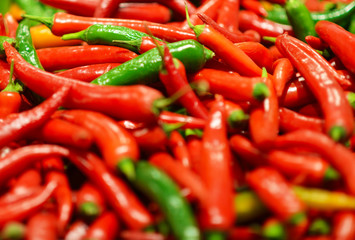 Red and green chili peppers at the background