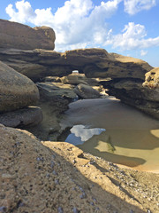 Fototapeta na wymiar Eroded rock formations on beach