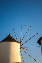 Windmill with wind blades. The sky is the background. Oia in the island of Santorini.