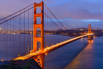 Sunset Golden Gate Bridge - A cloudy-winter-day sunset view of Golden Gate Bridge, looking from Hilltop at Marin Headlands toward San Francisco Peninsula at south. San Francisco, California, USA. 